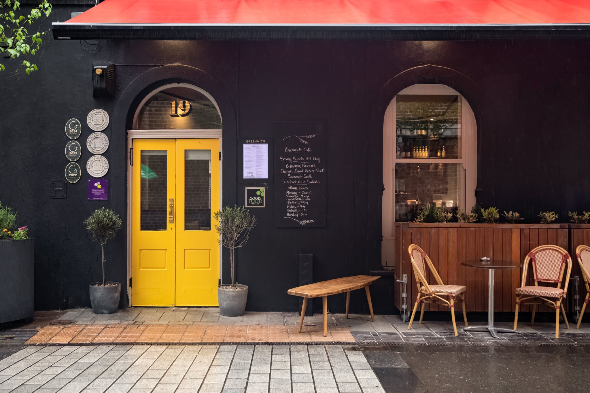 Black exterior and yellow entrance of Greenwich Cafe on Caroline Street in Cork